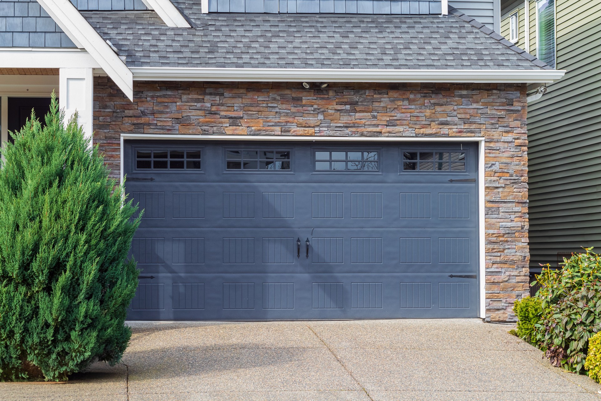 House with Garage door with windows. Garage door in luxury house. Metal garage door